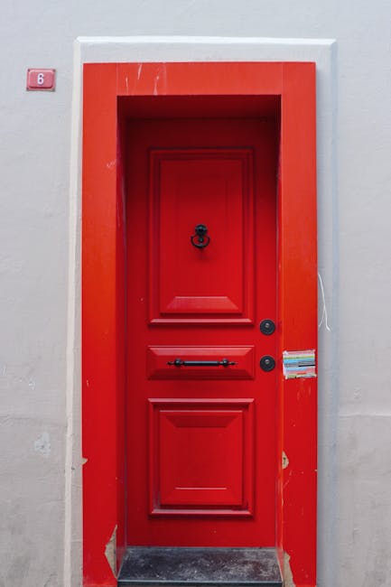 A bright red door with the number 6 above it